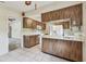 A kitchen featuring wood cabinets, white appliances, and tile flooring at 103 Hickory Creek Blvd, Brandon, FL 33511
