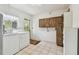 A laundry room with cabinets, tile flooring, a utility sink, a washer, and a dryer at 103 Hickory Creek Blvd, Brandon, FL 33511