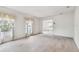 Bright and airy living room with large windows and neutral carpet, showcasing a seamless flow into other spaces at 103 Hickory Creek Blvd, Brandon, FL 33511