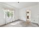 Living room featuring neutral carpet, white walls, and an entrance to the kitchen at 103 Hickory Creek Blvd, Brandon, FL 33511