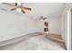 Open concept living room with neutral carpet, ceiling fans, and an opening into the kitchen at 103 Hickory Creek Blvd, Brandon, FL 33511