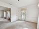 Living room featuring neutral carpet, white walls, and natural light from windows at 103 Hickory Creek Blvd, Brandon, FL 33511