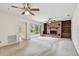 Bright living room featuring neutral carpet, a brick fireplace, built-in shelving, and a sliding glass door at 103 Hickory Creek Blvd, Brandon, FL 33511
