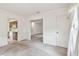 Living room featuring neutral carpet, white walls, and an entrance to the kitchen at 103 Hickory Creek Blvd, Brandon, FL 33511