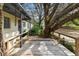 Cozy porch offers a welcoming entry with mature trees adding shade and charm at 103 Hickory Creek Blvd, Brandon, FL 33511