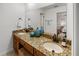 Bathroom featuring a double sink granite vanity with decorative blue vases and a view to the bedroom at 108 Biscayne Ave # B, Tampa, FL 33606