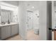 All-white bathroom showcasing a sleek vanity with a marble top and a glass-enclosed shower area at 108 Biscayne Ave # B, Tampa, FL 33606
