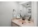 Cozy half bath featuring a round mirror, a unique sink, and minimalist decor at 108 Biscayne Ave # B, Tampa, FL 33606