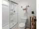 Modern bathroom with glass-enclosed shower and a white toilet, accented with decorative shelf and towel at 108 Biscayne Ave # B, Tampa, FL 33606
