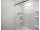 Modern shower stall with a glass door, built-in shelves, and a sleek shower head and handle at 108 Biscayne Ave # B, Tampa, FL 33606