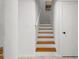 Bright staircase with contrasting white risers and wood treads, leading to a landing near a white door at 108 Biscayne Ave # B, Tampa, FL 33606