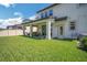 Spacious backyard with a covered patio, ideal for outdoor relaxation and enjoying the lovely outdoor scenery at 10945 Sundrift Dr, Tampa, FL 33647