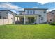 Lush backyard featuring a covered patio, perfect for outdoor gatherings and enjoying the serene outdoor space at 10945 Sundrift Dr, Tampa, FL 33647