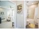 Bathroom with neutral tile, tub-shower combo and view into the main bedroom at 10945 Sundrift Dr, Tampa, FL 33647