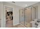 Bright bathroom featuring a glass shower stall and a walk-in closet at 10945 Sundrift Dr, Tampa, FL 33647