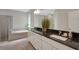 Bathroom with granite counters, double sinks, tiled floor, and large mirror at 10945 Sundrift Dr, Tampa, FL 33647