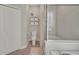 Bathroom featuring a toilet, towel rack, shelving, and shower with glass doors at 10945 Sundrift Dr, Tampa, FL 33647