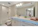 Bright bathroom featuring modern vanity with LED lighting, a shower-tub combo, and a large mirror at 10945 Sundrift Dr, Tampa, FL 33647
