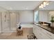 Serene bathroom featuring walk-in glass shower, soaking tub and modern fixtures at 10945 Sundrift Dr, Tampa, FL 33647