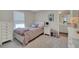 Cozy bedroom featuring white furniture, plush textures, and a stylish Audrey Hepburn-inspired art piece at 10945 Sundrift Dr, Tampa, FL 33647