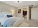 A bedroom featuring plush carpeting, a comfortable bed with stylish bedding, and a closet for storage at 10945 Sundrift Dr, Tampa, FL 33647
