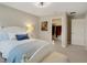 Comfortable bedroom featuring a queen-sized bed, ceiling fan and a walk-in closet at 10945 Sundrift Dr, Tampa, FL 33647