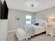 A bedroom featuring plush carpeting, a comfortable bed with stylish bedding, and a large window that lets in plenty of natural light at 10945 Sundrift Dr, Tampa, FL 33647