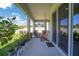 Inviting covered patio with ample seating, potted plants, and easy access to the home's interior through sliding glass doors at 10945 Sundrift Dr, Tampa, FL 33647