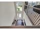 Bright foyer with chandelier, high ceiling, dark hardwood floor and staircase with wrought iron railing at 10945 Sundrift Dr, Tampa, FL 33647