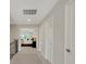 Hallway leading to the main bedroom with carpet flooring and multiple doors at 10945 Sundrift Dr, Tampa, FL 33647
