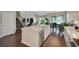 Open kitchen with a large island, white cabinets, and stainless steel appliances at 10945 Sundrift Dr, Tampa, FL 33647