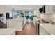 Bright kitchen with stainless appliances, white cabinets, and hardwood floors open to the dining area at 10945 Sundrift Dr, Tampa, FL 33647