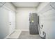 This laundry room features a washer and dryer, along with shelving for storage at 10945 Sundrift Dr, Tampa, FL 33647
