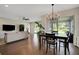 Open floor plan with hardwood floors, living room, and dining area with backyard access at 10945 Sundrift Dr, Tampa, FL 33647
