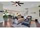 Comfortable living room with sofa, ottoman, and open view to the modern kitchen and stairs at 10945 Sundrift Dr, Tampa, FL 33647