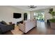 Cozy living room with large TV, modern sofa, and view of the outdoor patio at 10945 Sundrift Dr, Tampa, FL 33647