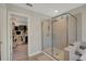 This bathroom features a glass enclosed shower and a spacious walk-in closet at 10945 Sundrift Dr, Tampa, FL 33647