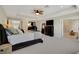 A spacious carpeted main bedroom featuring TV, ensuite bath, fan and tray ceilings at 10945 Sundrift Dr, Tampa, FL 33647