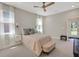 Main bedroom with neutral carpet, ceiling fan, and backyard access at 10945 Sundrift Dr, Tampa, FL 33647