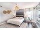 Bedroom features neutral decor, wood floors, soft textures, and a sliding barn door entrance to closet at 1106 Humble Haven St, Ruskin, FL 33570