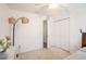 Bedroom featuring carpet, neutral walls, a ceiling fan, and a double-door closet at 1106 Humble Haven St, Ruskin, FL 33570