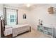 Bedroom featuring carpet, neutral walls, a ceiling fan, and a window with natural lighting at 1106 Humble Haven St, Ruskin, FL 33570
