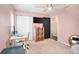 Bright bedroom features a ceiling fan, closet, and desk area, providing a functional and comfortable space at 1106 Humble Haven St, Ruskin, FL 33570