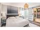 Spacious bedroom with hardwood floors, neutral walls, and a barn door entrance to the closet at 1106 Humble Haven St, Ruskin, FL 33570