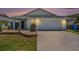 Inviting single-story home with a well-manicured lawn, a small patio, and an attached garage at 1106 Humble Haven St, Ruskin, FL 33570