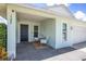 Cozy front porch featuring modern chairs and a table, offering a welcoming entrance to the home at 1106 Humble Haven St, Ruskin, FL 33570