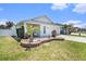 Charming single-story home with a well-manicured lawn, a small patio, and an attached garage at 1106 Humble Haven St, Ruskin, FL 33570