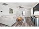 Spacious living room featuring a large sectional sofa, modern ceiling fan, and stylish decor at 1106 Humble Haven St, Ruskin, FL 33570