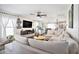 Bright living room featuring a large sectional sofa, modern ceiling fan, and contemporary entertainment center at 1106 Humble Haven St, Ruskin, FL 33570