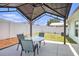 Outdoor patio with covered area and fan, providing shade and comfort for outdoor relaxation and dining at 1106 Humble Haven St, Ruskin, FL 33570